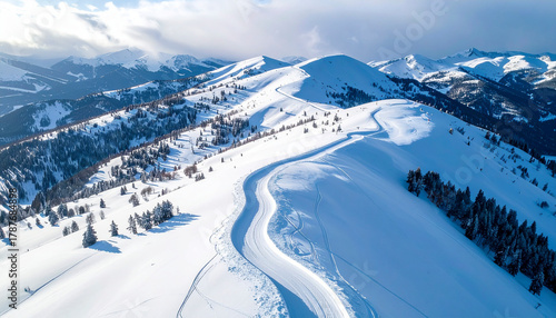 Aerial view of snow-covered mountain slopes with ski tracks