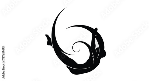 Graceful silhouette of a person in a dynamic aerial yoga pose, embodying strength and flexibility.