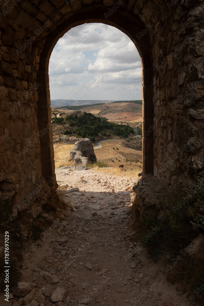 Obraz premium View of the scenic landscape from an ancient archway in Atienza, Guadalajara, Spain, showcasing natural beauty and historical architecture