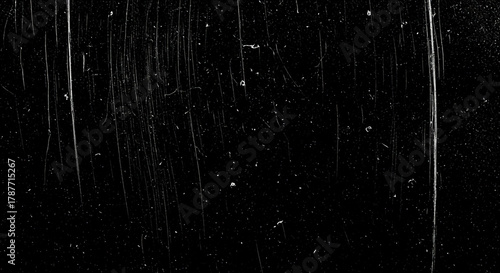 Black scratched film texture abstract grunge background with dust and damage perfect for overlay and vintage effects