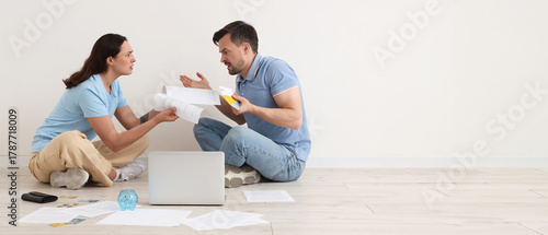 Depressed young couple sitt...