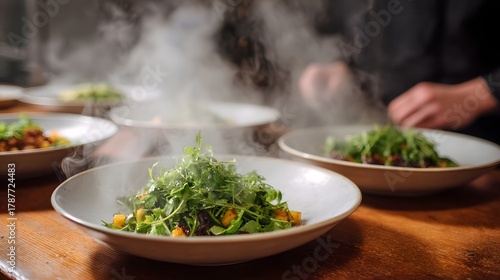 Fototapeta Naklejka Na Ścianę i Meble -  Steaming fresh salads with greens and ingredients served in bowls on a rustic wooden table