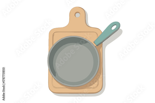 Papier peint Frying pan with handle resting on wooden cutting board