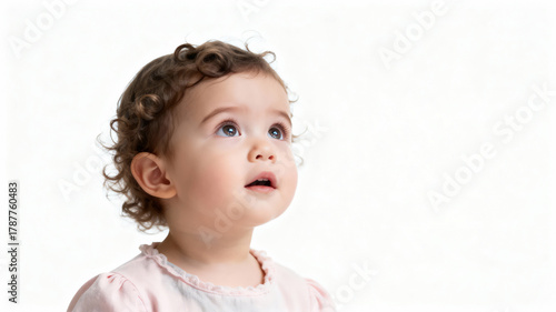 Portrait of a curly-haired little girl 2-3 years old looking up