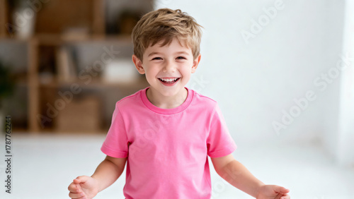 Portrait of European joyful 5-year-old boy in a T-shirt on a white background