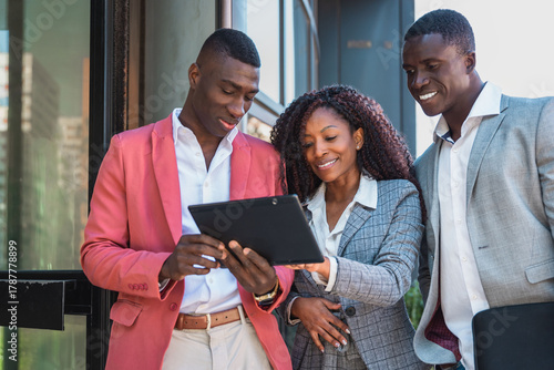 Diverse multiracial Business people using tablet outside office building