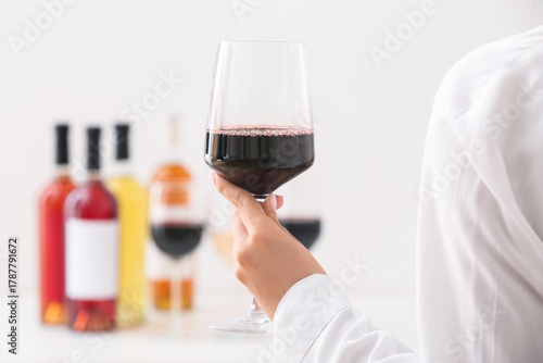 Female hand with glass of e...