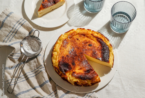 Basque Cheesecake in Natural Sunlight on Linen Tablecloth