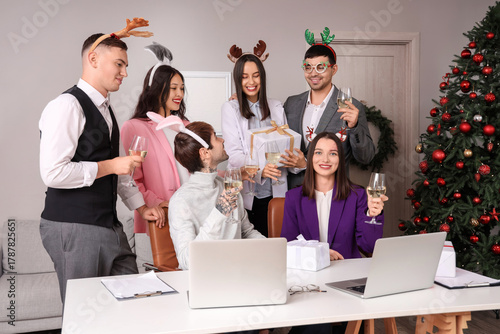Happy young colleagues with...