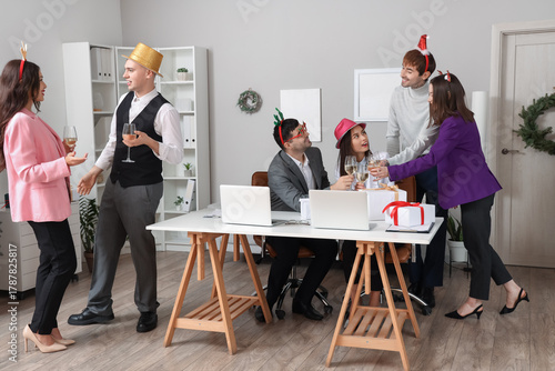 Happy young colleagues with...
