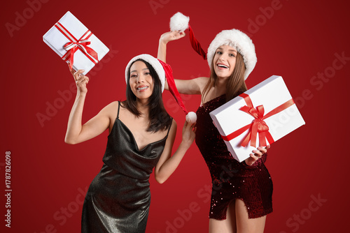 Young women in Santa hats w...