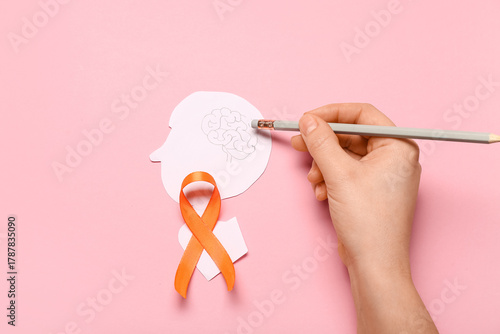 Female hand with orange rib...