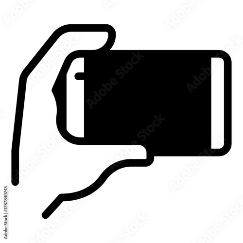 Smartphone held horizontally in hand solid icon, using smart device concept, touchscreen phone sign on white background, glyph style for mobile web design. Vector graphics.