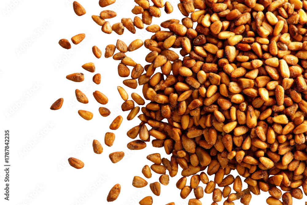 Obraz premium Gourmet Pine Nuts: A close-up shot captures a scattering of roasted pine nuts. These culinary gems are a testament to nature's bounty and culinary excellence
