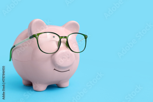 Piggy bank in eyeglasses on...