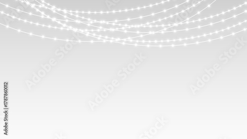 Garland decorated with festive lights ribbons and glowing bulbs on Christmas holiday stage.
