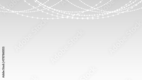 Garland decorated with glowing lights and festive ribbons across Christmas holiday stage banner.
