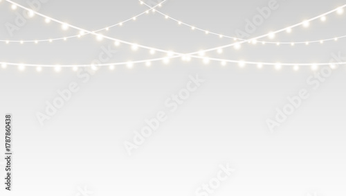 Garland decorated with glowing fairy lights and festive ribbons across Christmas holiday stage.
