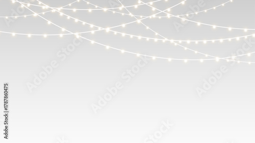 Garland hanging with glowing ribbons and bulbs across festive Christmas holiday card stage.
