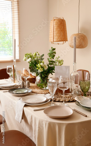 Beautiful table setting with eustoma flowers for wedding celebration in room
