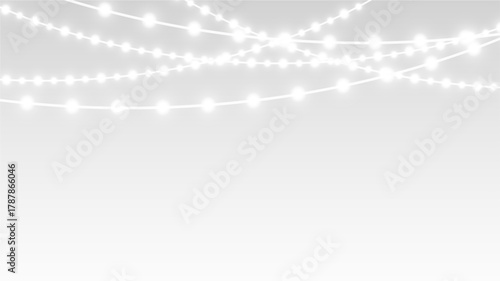 Garland with festive ribbons and glowing lights decorating christmas holiday banner and stage.
