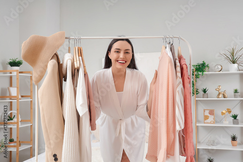 Young woman near rack with ...