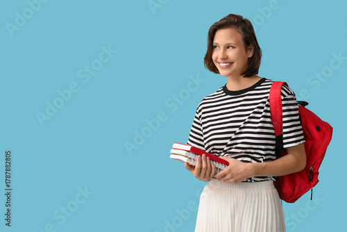Happy female student with b...