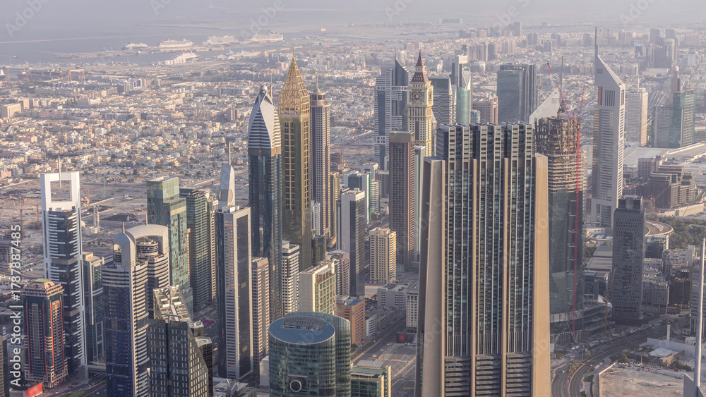 Fototapeta premium Downtown of Dubai in the morning timelapse after sunrise. Aerial view with towers and skyscrapers