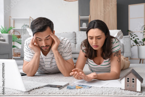 Young couple lying on floor...