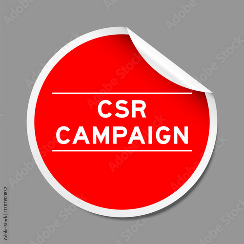Red color peel sticker label with word CSR (Abbreviation of corporate social responsibility) campaign on gray background