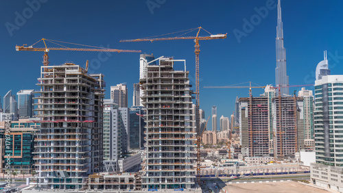 Photography Aerial view of a skyscrapers under construction with huge cranes timelapse in Dubai