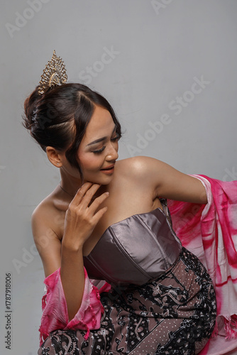 Smiling Asian model posing in elegant gown