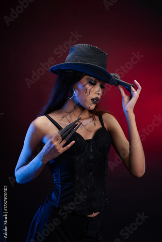 Gothic woman posing with fingers gesture