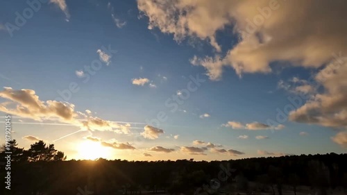 Beautiful sunset over the mountains with orange and blue sky and clouds at dusk