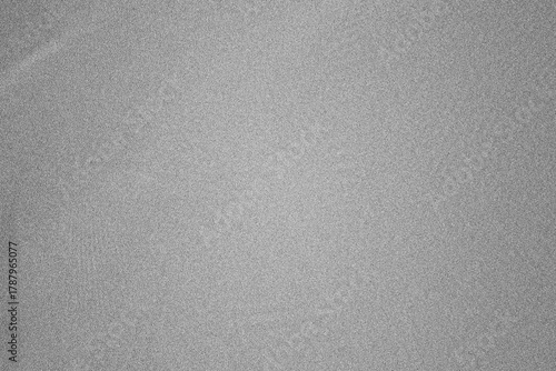 Grey abstract grainy texture background with speckled noise effect