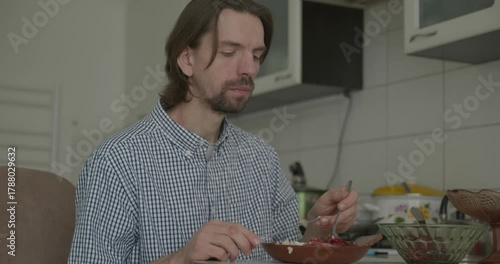 Man is Eating Breakfast in Kitchen. 4K 10-bit