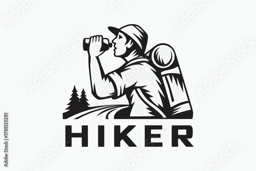 The hiker drinks from his water bottle, pausing on a trail near evergreen trees