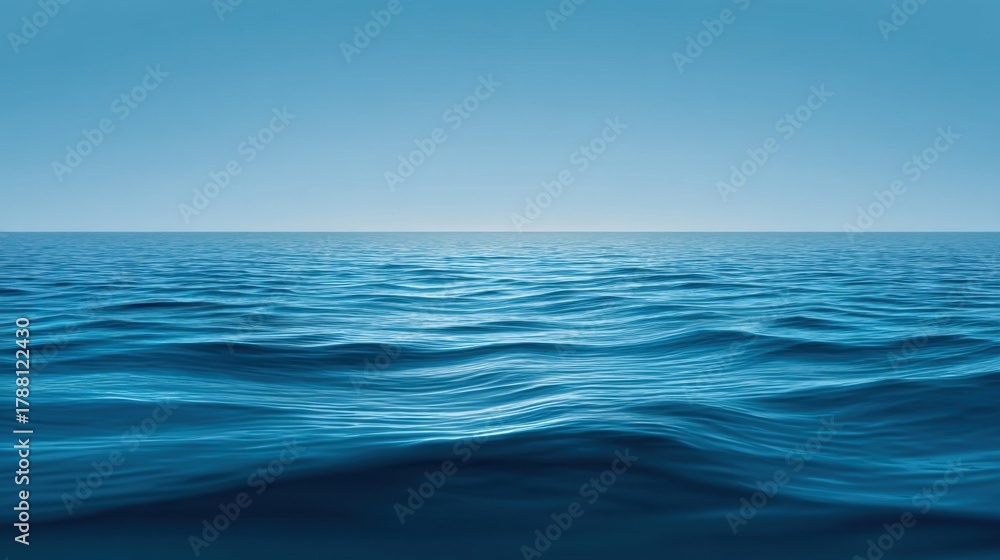 Obraz premium Tranquil Blue Ocean Surface with Gentle Waves Under Clear Sky, Ideal for Relaxation, Nature Scenes, and Inspirational Themes