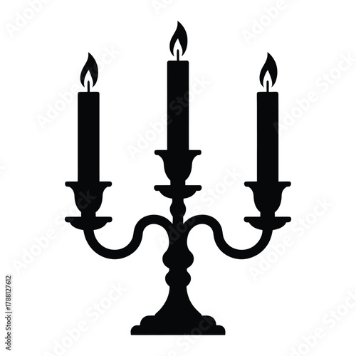 Silhouette of a three branched candelabra with lit candles