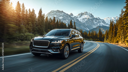 Black SUV driving on a scenic mountain road with a beautiful landscape view