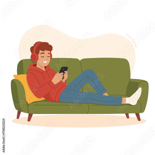 teenage boy lying on the couch and using smartphone with headphones on. Concept of screen addiction, social media dependence, technology overuse, and teenage isolation in the digital era.