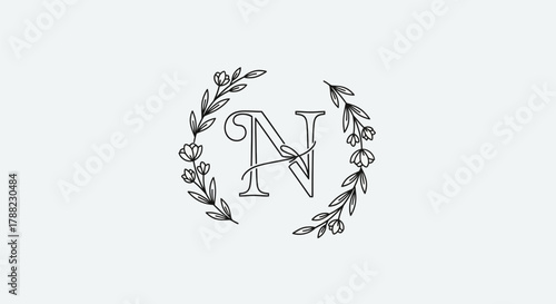 Elegant initial letter N surrounded by a delicate floral wreath for sophisticated designs