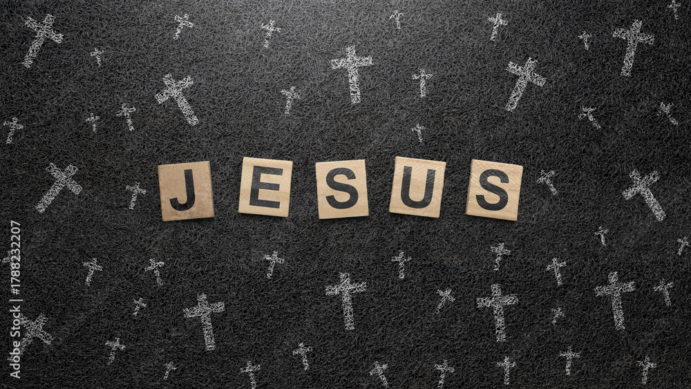 Fototapeta premium Christian cross and wooden cubes with Jesus text on a black background. Concept of Christianity, religious, faith, Jesus, or belief
