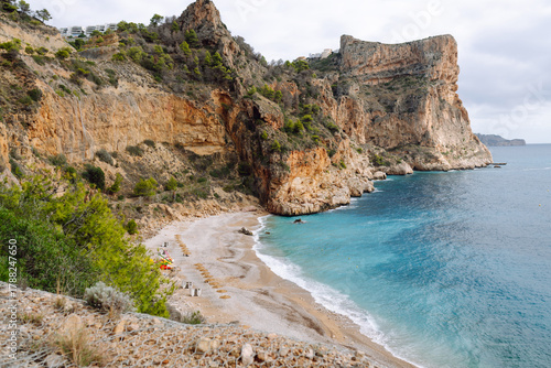 Fototapeta Naklejka Na Ścianę i Meble -  Seascape. Rocky cliffs with calm turquoise waters. Coastal landscape. Secluded bay with a beach surrounded by a vibrant sea. Nature concept.