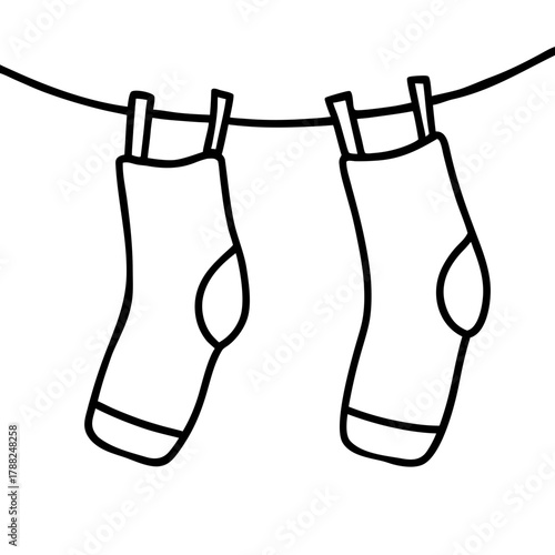 Two socks hanging on a clothesline with clothespins