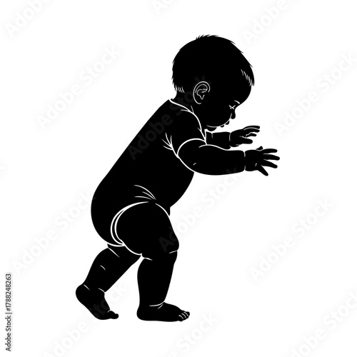 Silhouette of a baby learning to walk