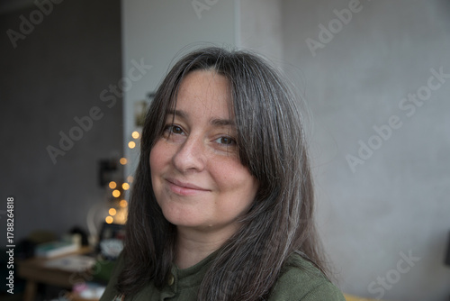 Portrait of a 43-year-old woman with gray hair