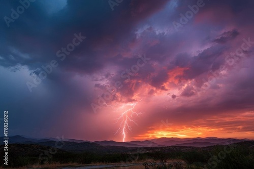 Quadro em tela Dramatic Lightning Strike at Sunset Over Distant Mountains.