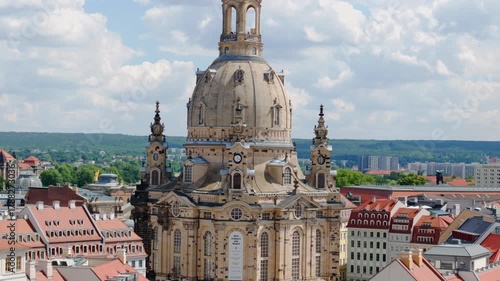 The drone captures Dresden’s Frauenkirche from above, showcasing its baroque architecture and the surrounding old town under clear summer skies.