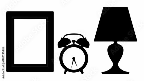 Silhouette of a picture frame an alarm clock and a lamp on a white background in a still life style